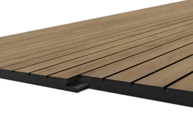 Low-angle view of brown wooden decking boards laid in parallel over a black support frame, showing gaps between planks.