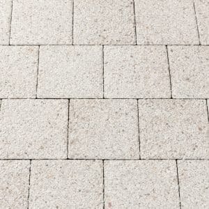 Light-gray concrete pavers arranged in a brick-like rectangular pattern with visible grout lines.