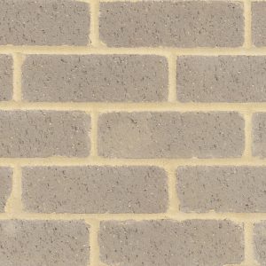 Brick wall pattern with rectangular gray bricks and tan mortar joints