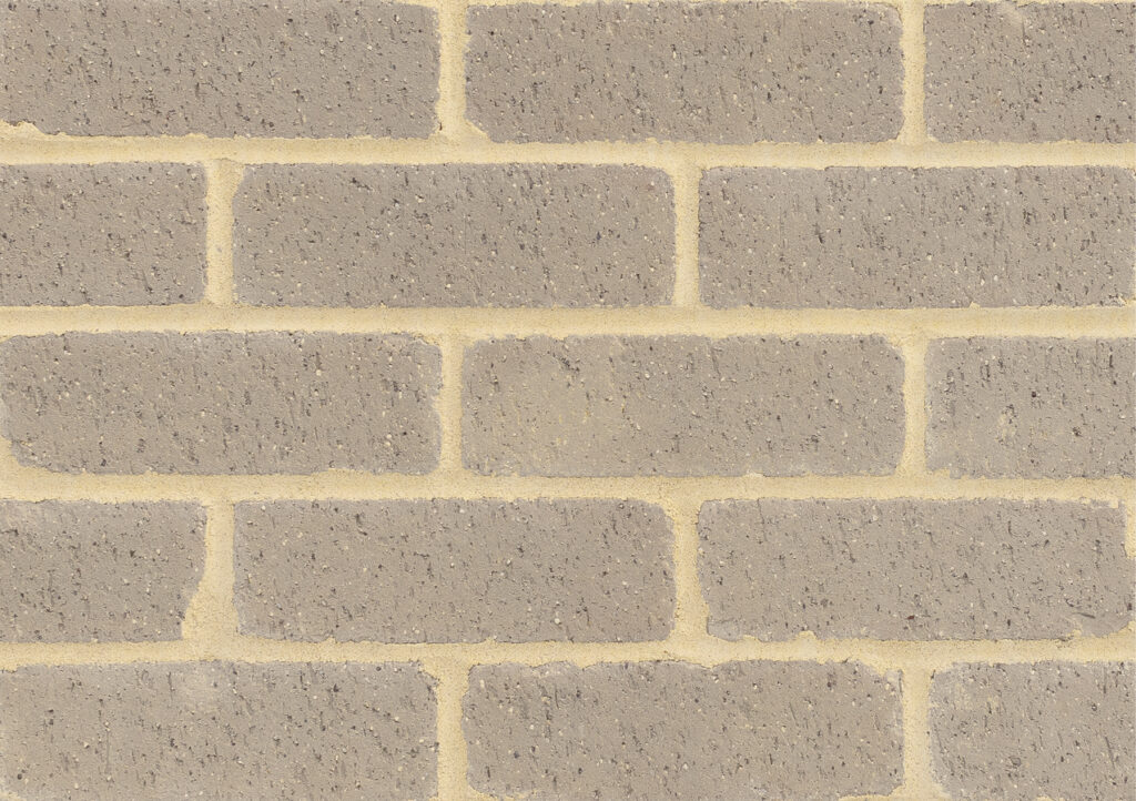 Brick wall pattern with rectangular gray bricks and tan mortar joints