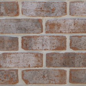 Close-up of a red‑brown brick wall with light gray mortar