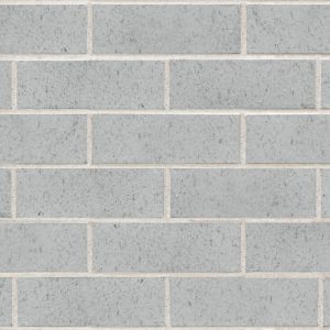 Light gray brick wall with uniform rectangular bricks and light tan mortar joints.