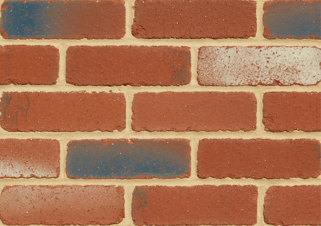 Close-up of a brick wall with red bricks and a few blue-painted bricks, showing textured mortar lines.
