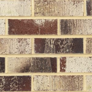 Close-up of a brick wall with light tan mortar and brown/beige bricks in varying tones.