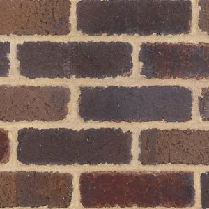 Close-up of a brown brick wall with light tan mortar.