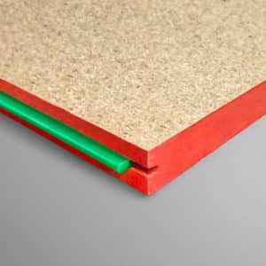 Close-up of red-edged panel corner with beige core and a green plastic spacer underneath.