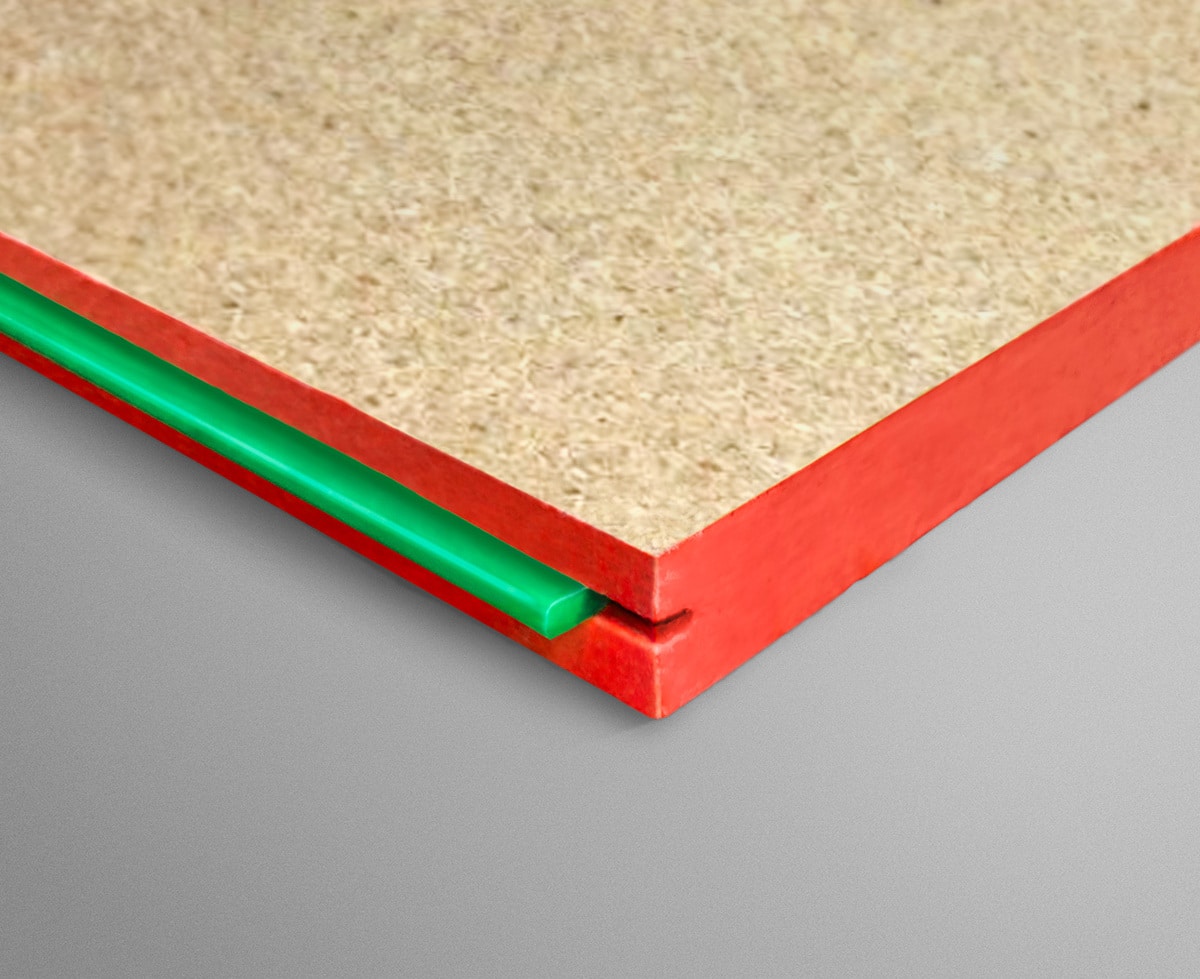 Close-up of red-edged panel corner with beige core and a green plastic spacer underneath.