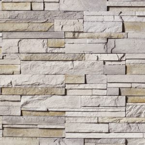 Stone veneer wall with horizontally stacked rectangular limestone-like blocks in gray/beige tones and rough texture.