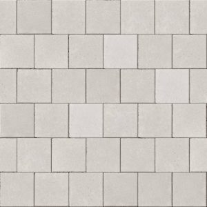 Light gray rectangular concrete blocks arranged in a brick-like pattern forming a wall or pavement.