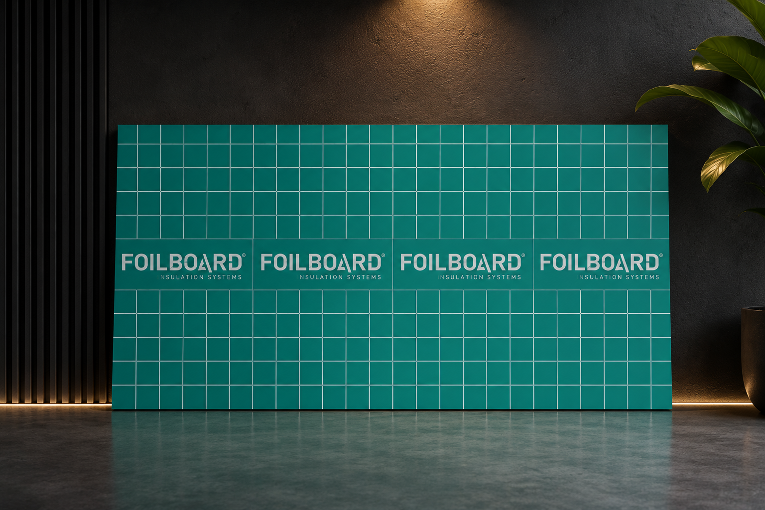 Teal grid-patterned display board with the 'FOILBOARD' insulation logo repeated along its width in a modern interior.