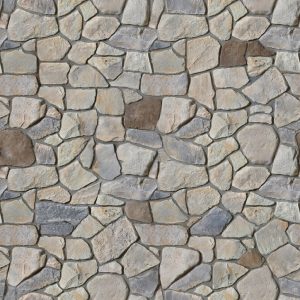 Irregular stone wall with a mosaic of gray, tan, and brown stones fitting tightly together