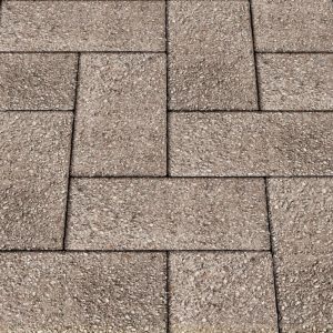 Close-up of textured brown concrete pavers arranged in an interlocking pattern for a paved surface.